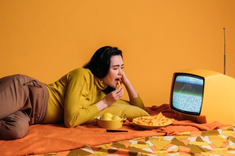Person laying on side watching TV