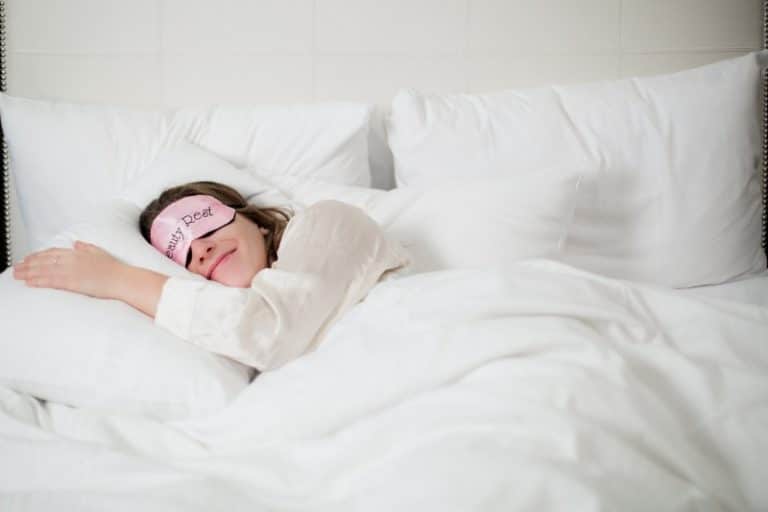 Person sleeping on bed with smile on face