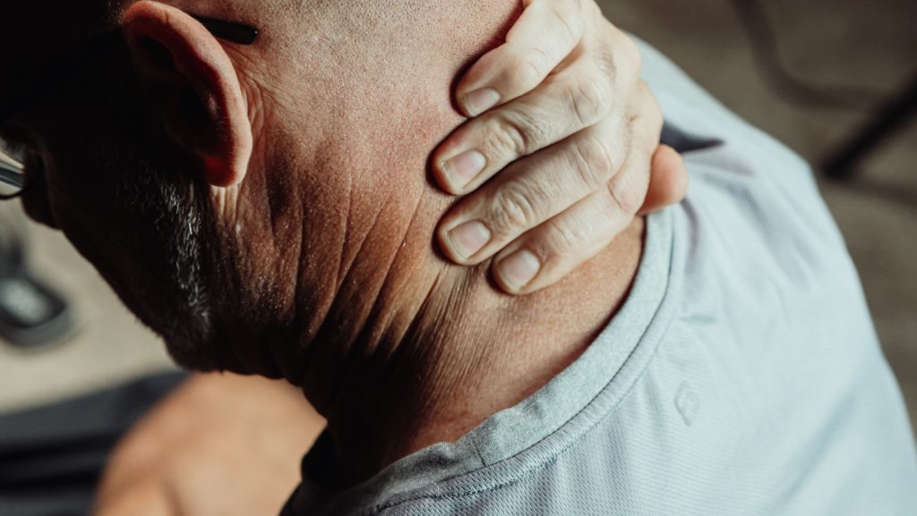 Person holding his neck in pain