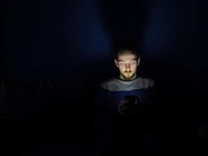 Person looking at phone in the dark