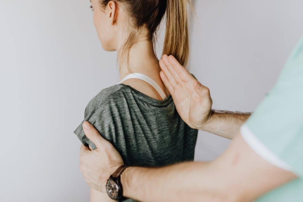 Doctor correcting spinal alignment of patient