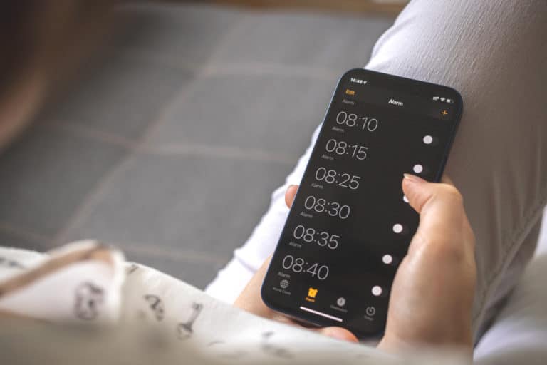 Phone screen with multiple alarms set to wake up in the morning