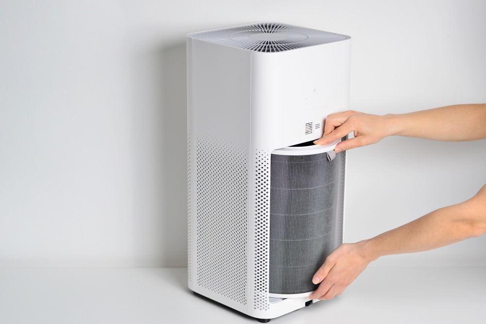 An air purifier filter being replaced