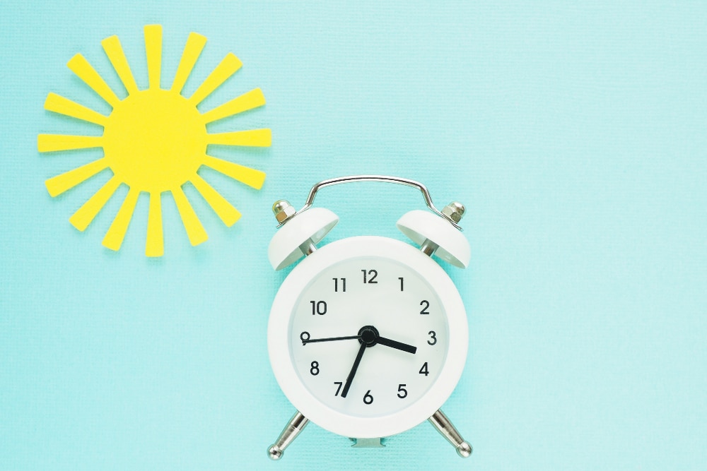 Clock and a cutout of a sun rising