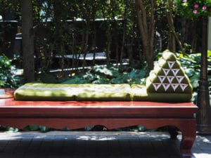 Thai triangle pillow on an elevated platform surrounded in nature