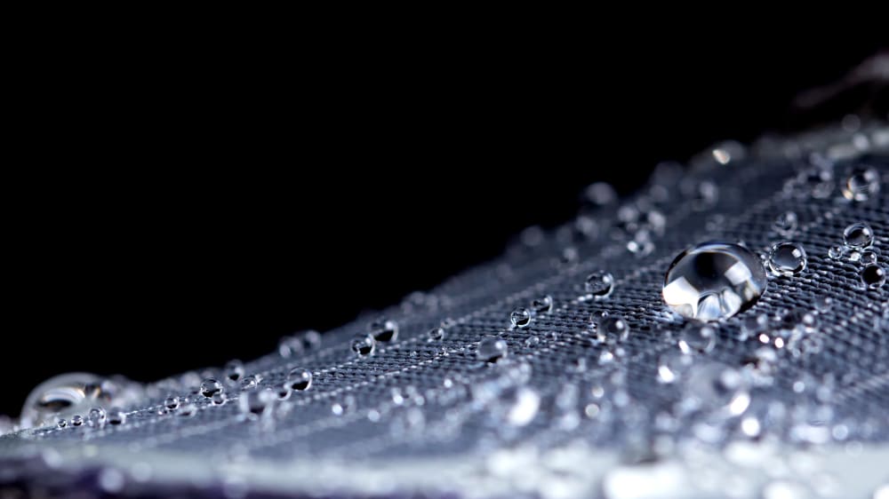 Close up of water droplets bouncing off surface